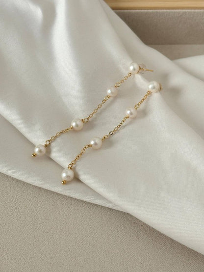 Long string oval pearl earring